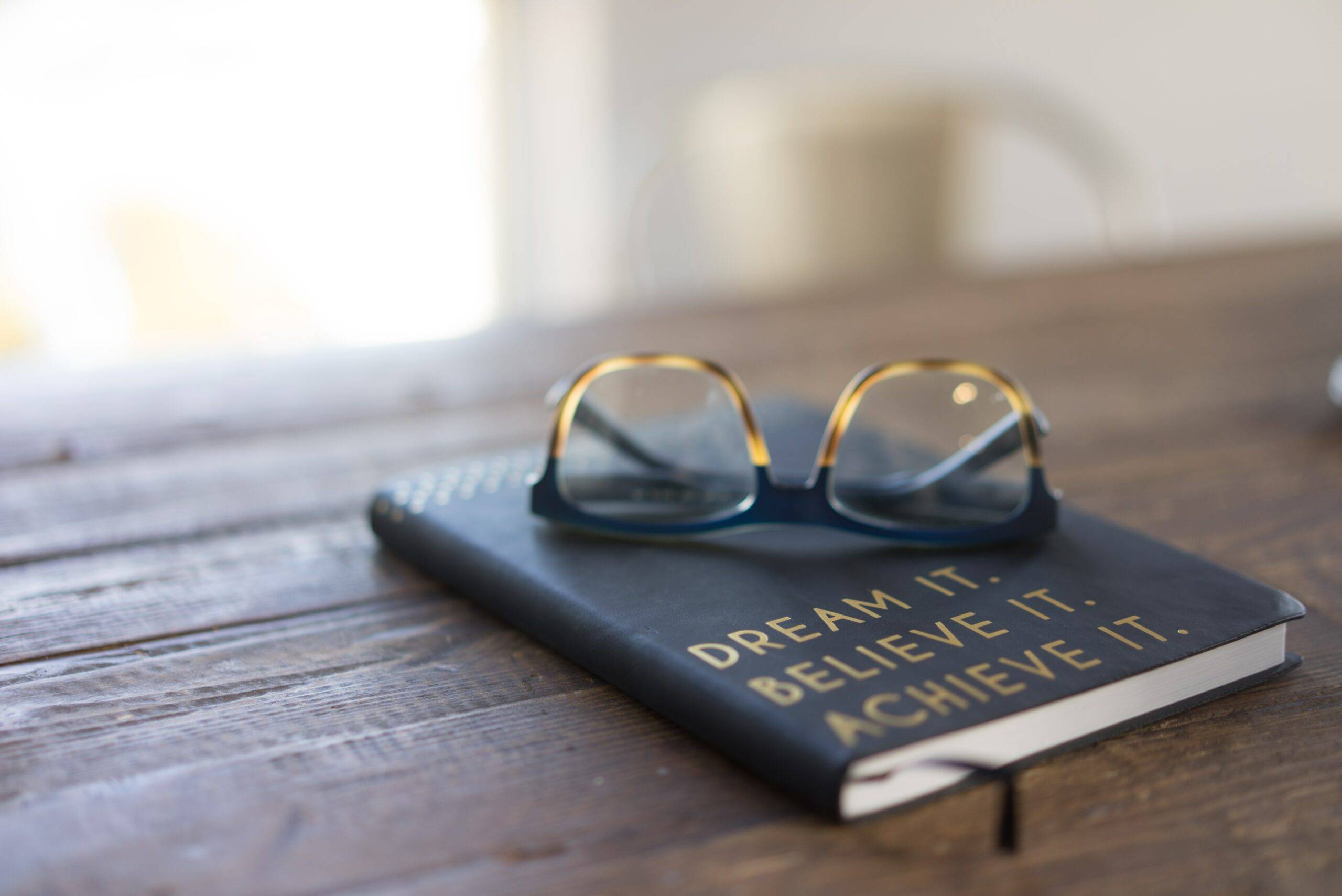 Pair of spectacles on top of a book
