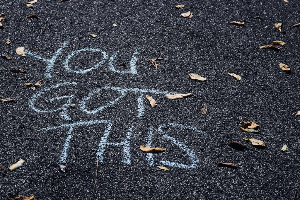 You Got This text written on blacktop pavement with white chalk